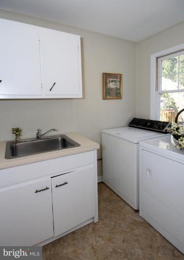 5631 Inverchapel Road Springfield, VA 22151 - Photo 23 of 30 a utility room with cabinets washer and dryer