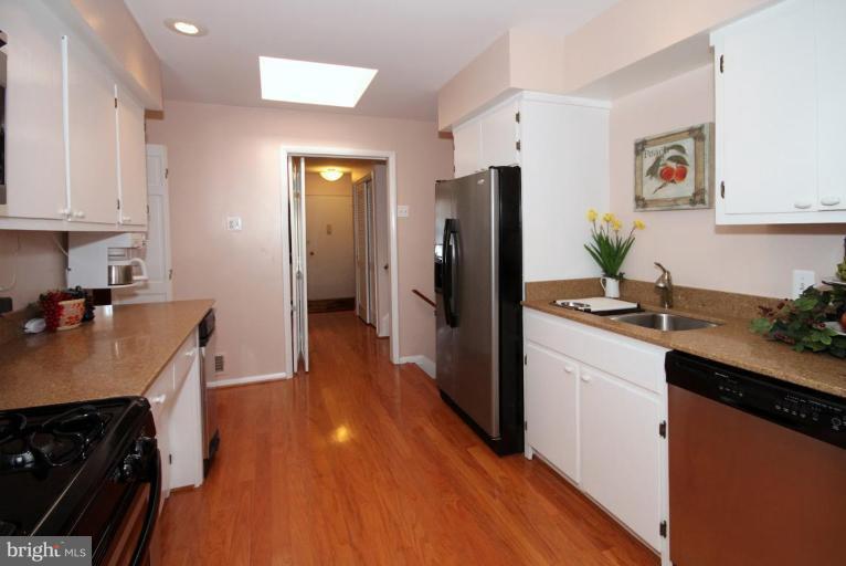 5631 Inverchapel Road Springfield, VA 22151 - Photo 10 of 30 a kitchen with stainless steel appliances a refrigerator sink and wooden floor