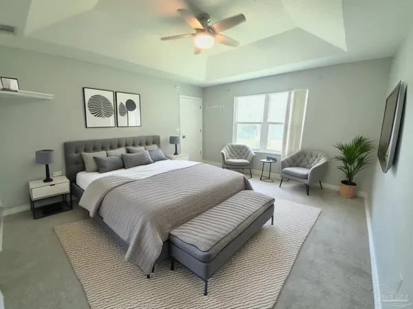 a bedroom with a large bed and a couch