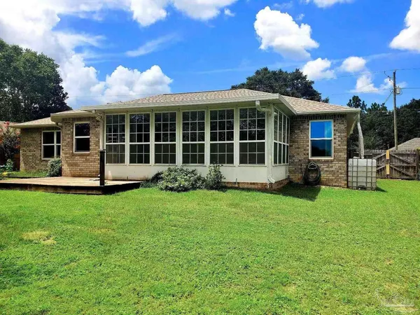 a view of a house with backyard and porch