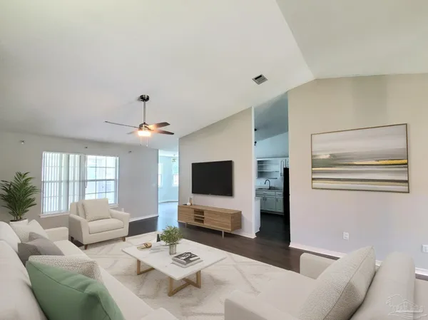 a living room with furniture and a flat screen tv