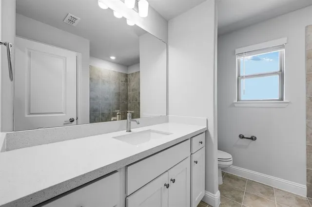 a bathroom with a sink a toilet and a mirror