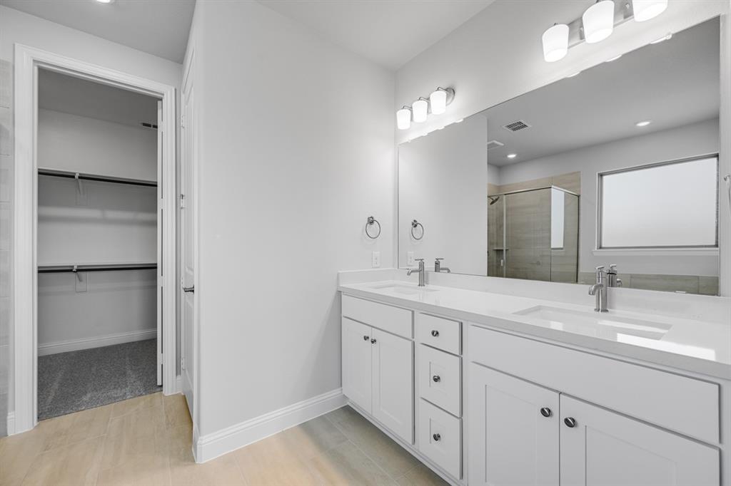 522 Bull Street Oak Point, TX 75068 - Photo 13 of 36 a bathroom with a double vanity sink double and mirror