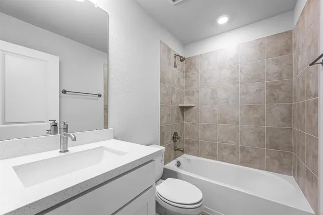 a bathroom with a sink a toilet and a bathtub