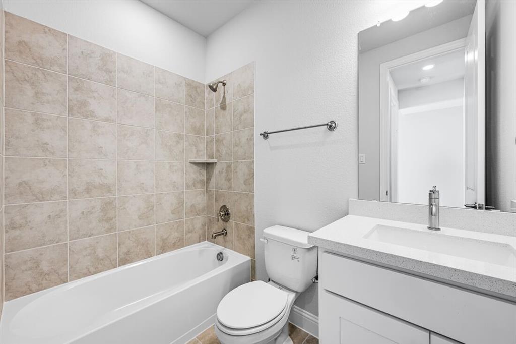 522 Bull Street Oak Point, TX 75068 - Photo 24 of 36 a bathroom with a sink a toilet and a bathtub