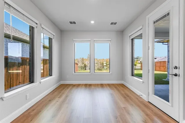 a view of an entryway with wooden floor and door