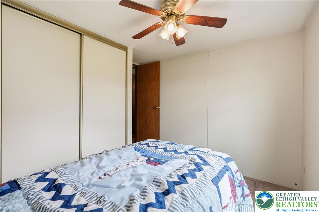 3101 Newburg Road Nazareth, PA 18064 - Photo 18 of 23 a bedroom with a bed and a chandelier