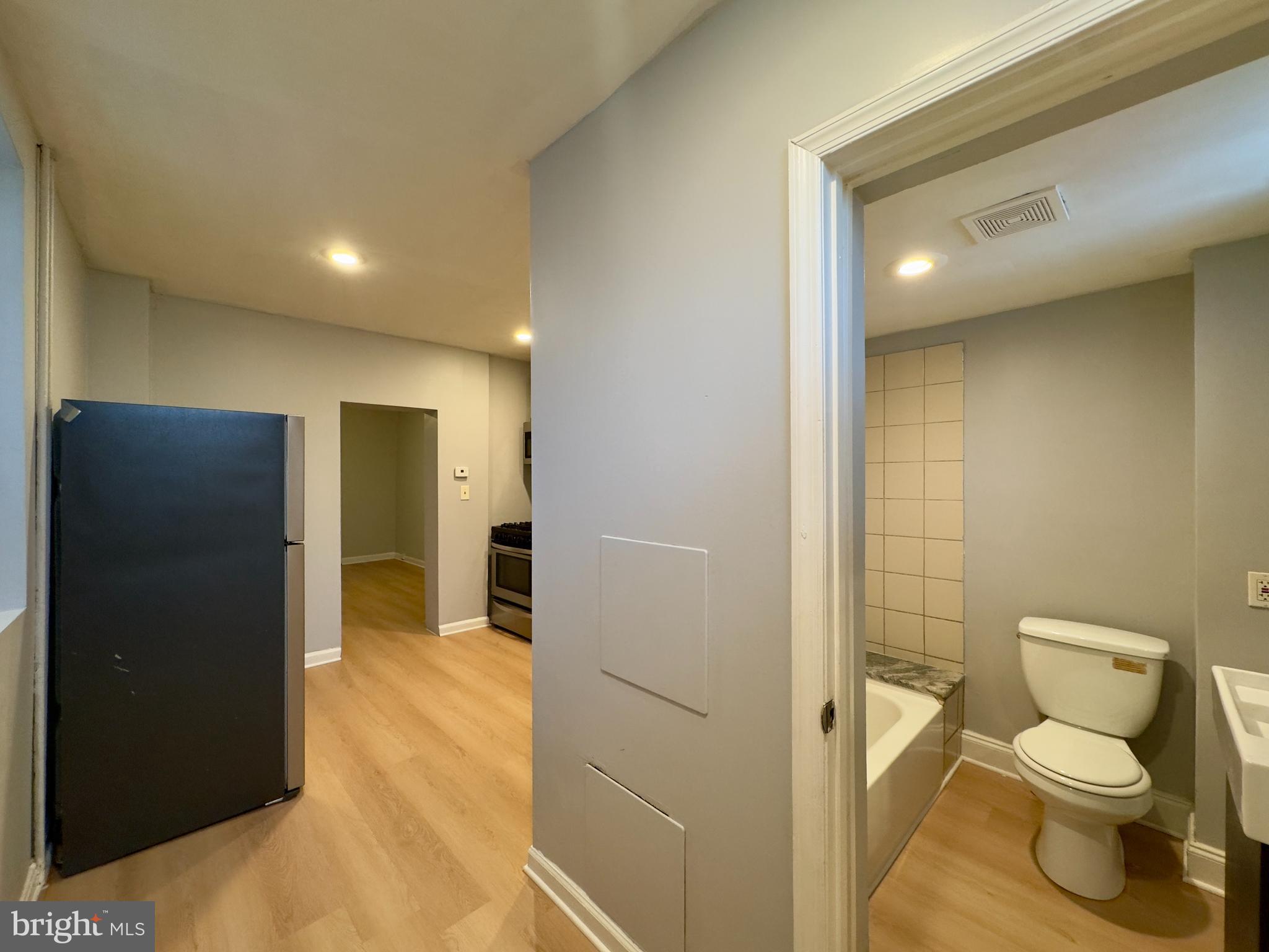 408 South Conkling Street, Unit 1 Baltimore, MD 21224 - Photo 10 of 14 a bathroom with a toilet and a shower