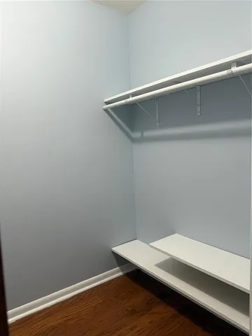 a room with a desk and wooden floor