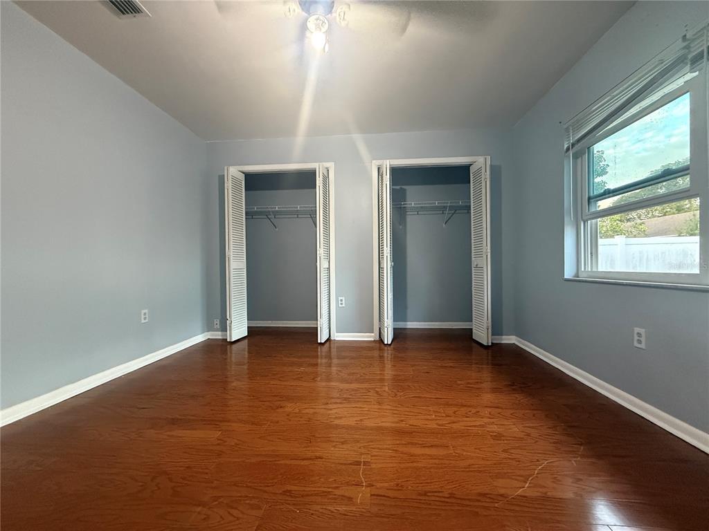 8840 Martinique Lane Port Richey, FL 34668 - Photo 23 of 31 an empty room with windows and closet