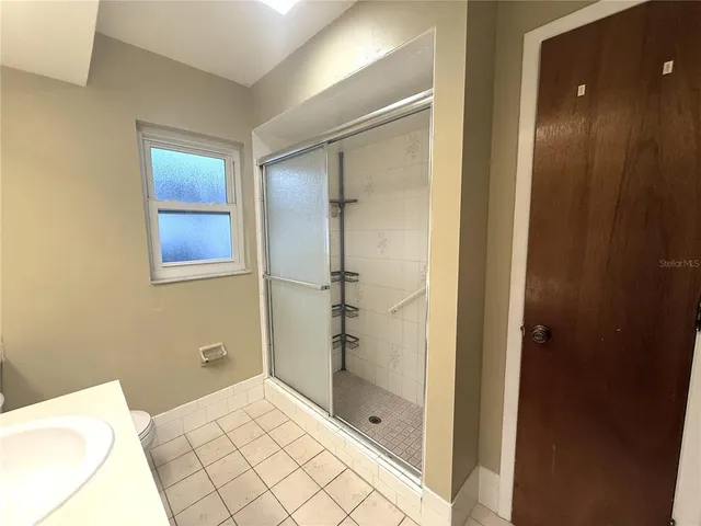 a bathroom with a shower and a sink