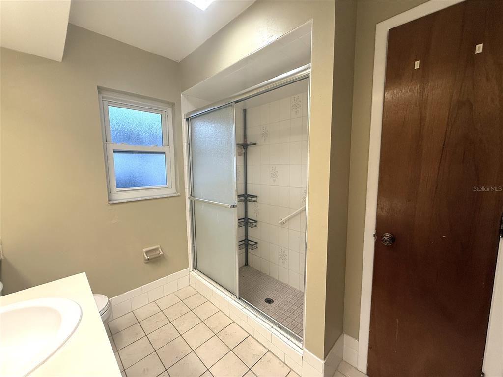 8840 Martinique Lane Port Richey, FL 34668 - Photo 26 of 31 a bathroom with a shower and a sink
