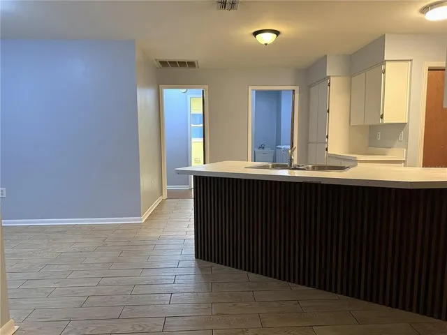 a kitchen with granite countertop a sink and a wooden cabinets