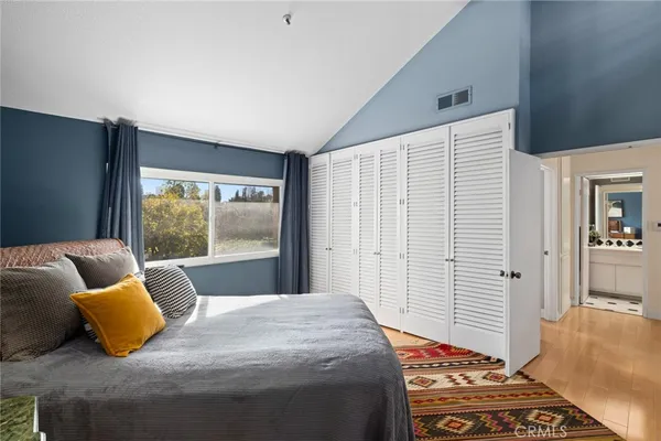 a bedroom with a bed and glass window