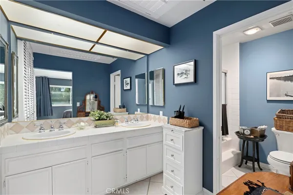 a view of bathroom with dual sinks