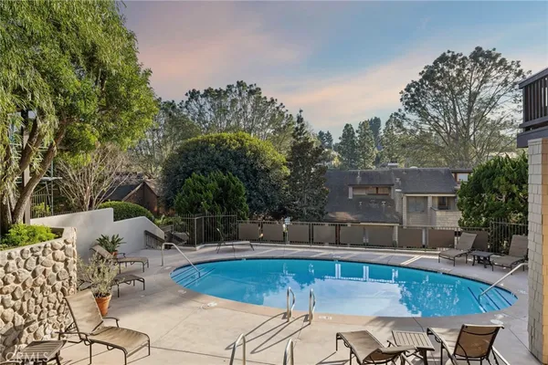 a view of a swimming pool with chairs
