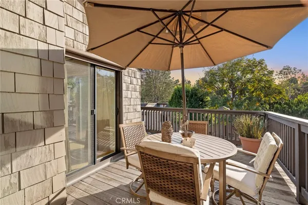 a view of balcony with furniture and umbrella