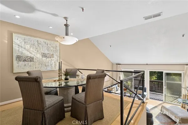 a dining room with furniture a chandelier and window