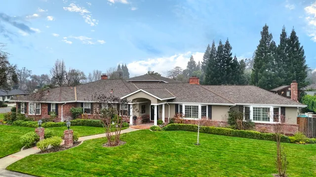 a aerial view of a white house that has a yard