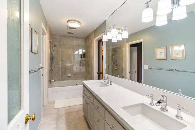 a bathroom with a granite countertop shower sink and mirror
