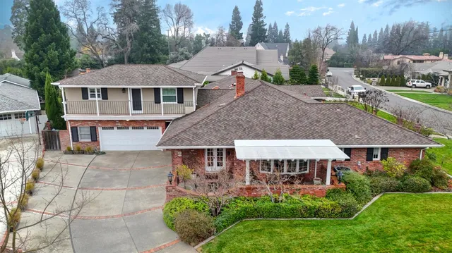 a aerial view of a house with a yard patio and furniture