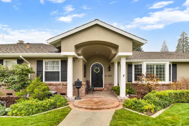 a front view of a house with garden