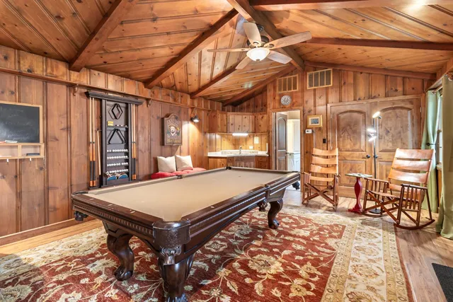 a backyard of a house with table and chairs potted plants