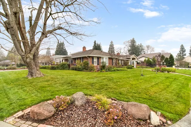 an aerial view of a house with swimming pool and big yard