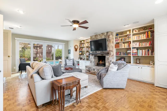 a living room with fireplace furniture and a flat screen tv