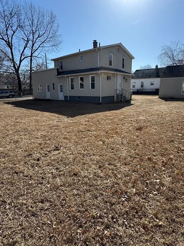 a view of a house with wooden fence