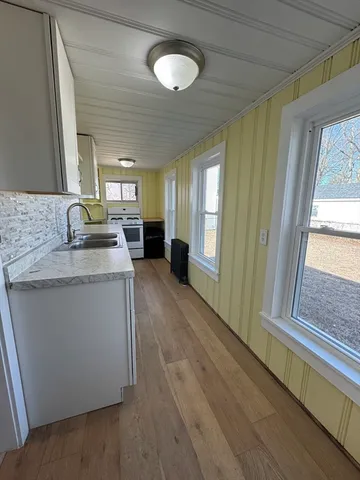 a kitchen with stainless steel appliances granite countertop a sink stove and cabinets