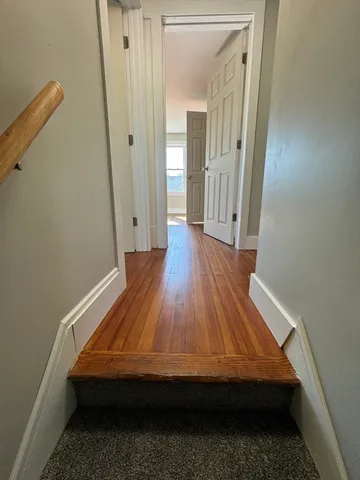 a room with wooden floor and glass door