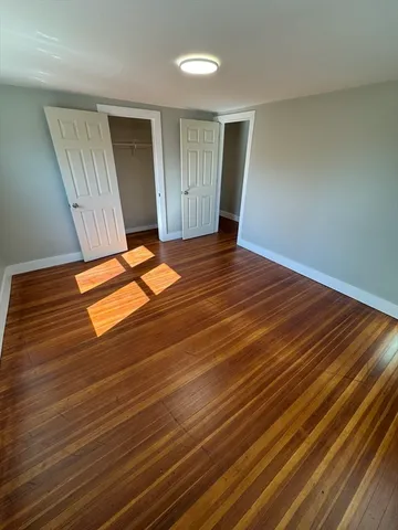 an empty room with wooden floor