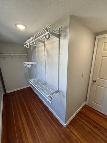 a view of a room with wooden floor