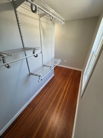 a view of a room with wooden floor