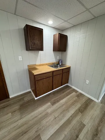 a bathroom with a granite countertop toilet a sink and a mirror