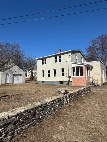 a view of a white house with a yard