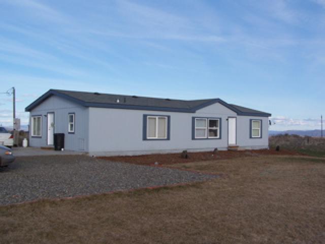 1256 Slavin Heights Road Yakima, WA 98903 - Photo 1 of 3 a front view of house with yard and trees