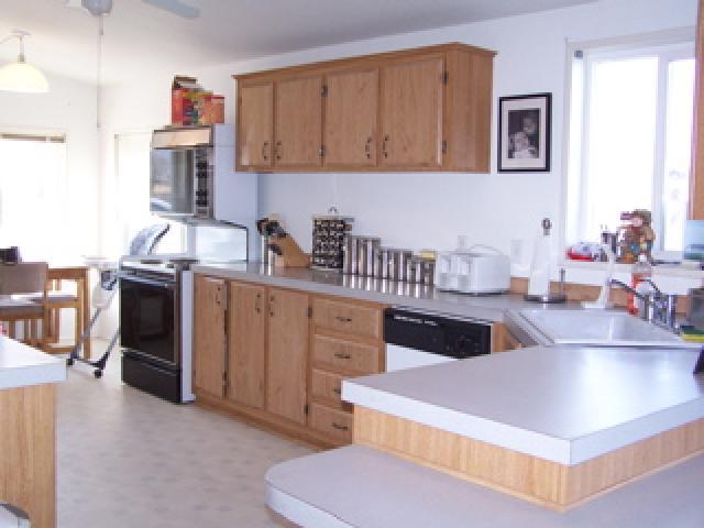 1256 Slavin Heights Road Yakima, WA 98903 - Photo 3 of 3 a kitchen with stainless steel appliances a sink a stove and a refrigerator