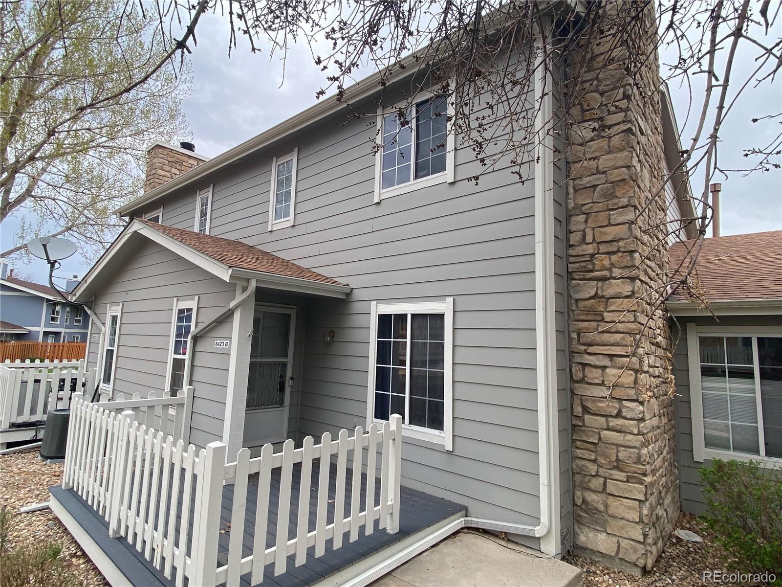 8423 Everett Way, Unit B Arvada, CO 80005 - Photo 1 of 27 a porch with a bench