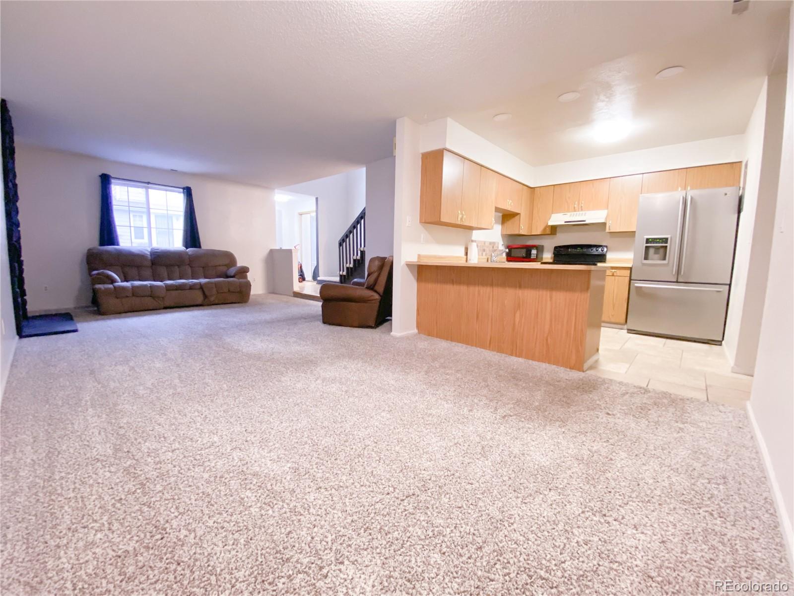 8423 Everett Way, Unit B Arvada, CO 80005 - Photo 14 of 27 a view of a livingroom with furniture and a flat screen tv