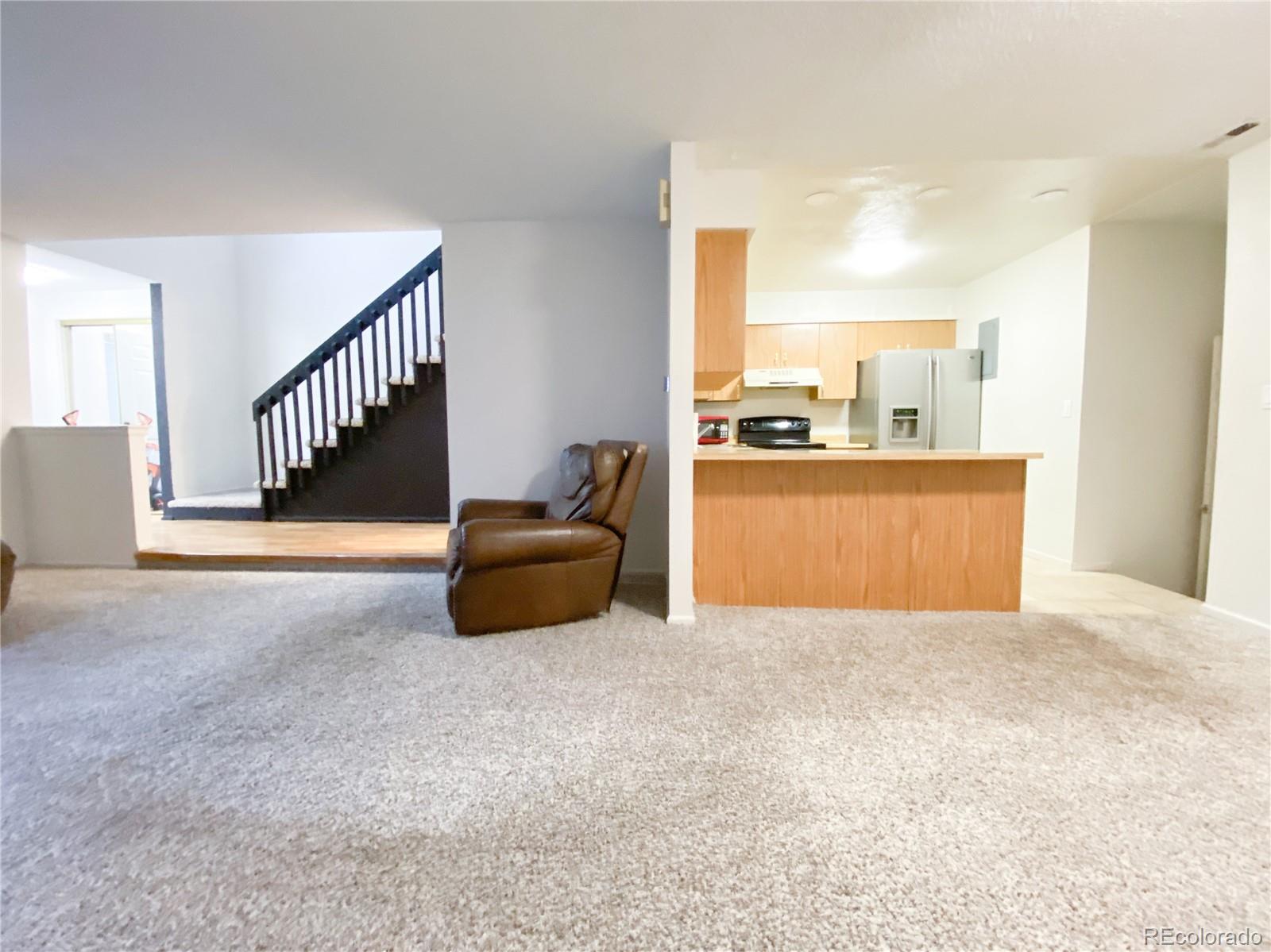 8423 Everett Way, Unit B Arvada, CO 80005 - Photo 15 of 27 a view of an empty room with stairs