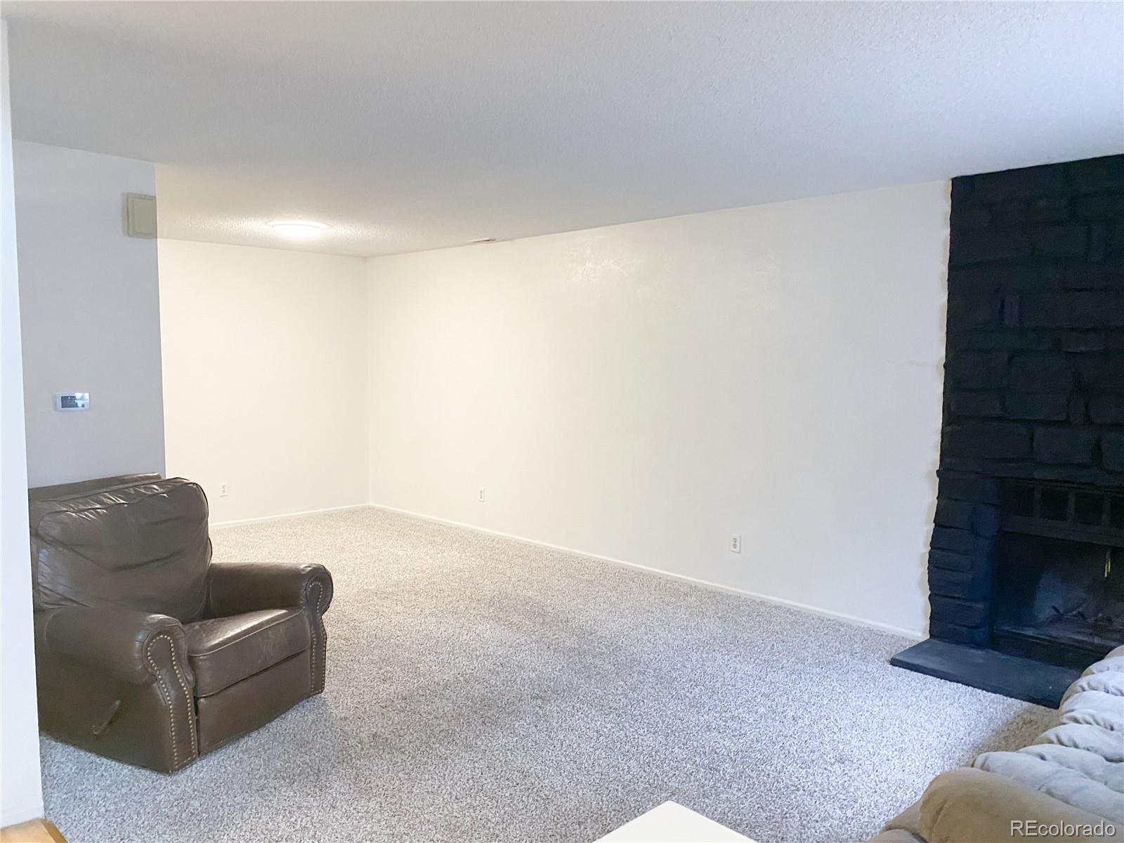 8423 Everett Way, Unit B Arvada, CO 80005 - Photo 7 of 27 a living room with furniture and a fireplace
