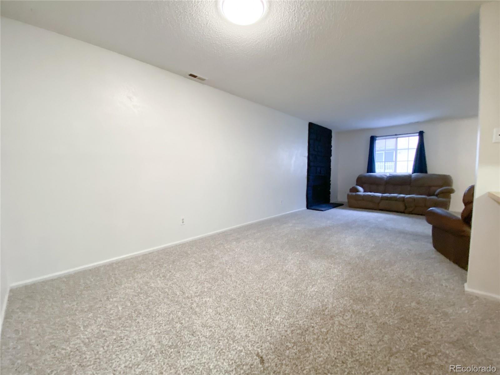 8423 Everett Way, Unit B Arvada, CO 80005 - Photo 9 of 27 a bedroom with a bed and a potted plant on the dresser