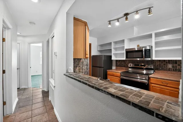 a kitchen with a stove a sink and a refrigerator