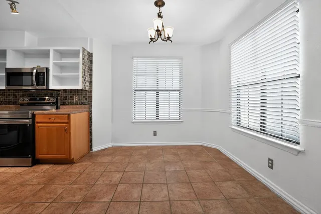 a stove top oven sitting inside of a kitchen