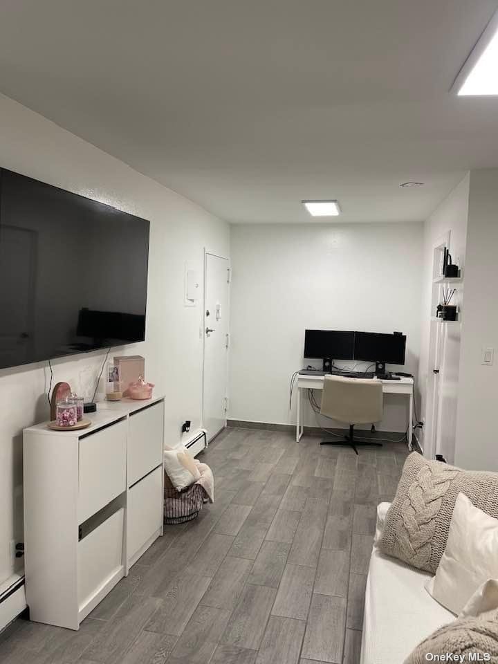 Undisclosed Address Queens, NY 11368 - Photo 4 of 9 a living room with furniture and a flat screen tv