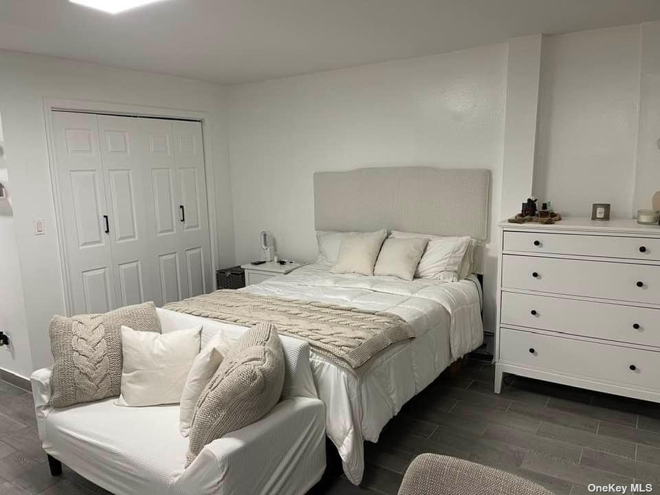 Undisclosed Address Queens, NY 11368 - Photo 6 of 9 a bedroom with a bed and a dresser