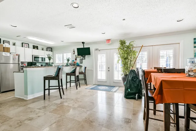 a living room with furniture and a dining table with kitchen view