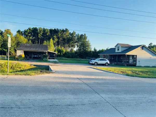 a view of swimming pool with lawn chairs and plants